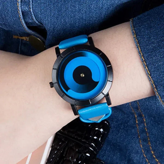 Wrist wearing a blue and black watch with denim background