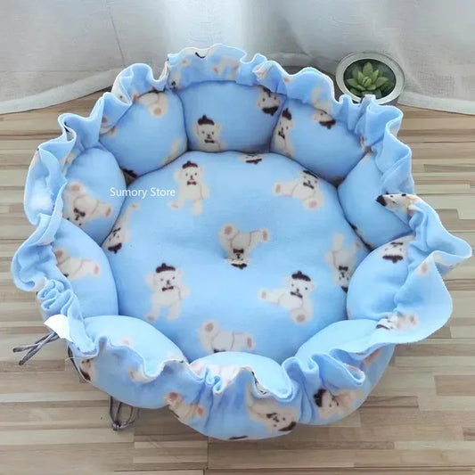 Blue pet bed with teddy bear pattern on a wooden floor
