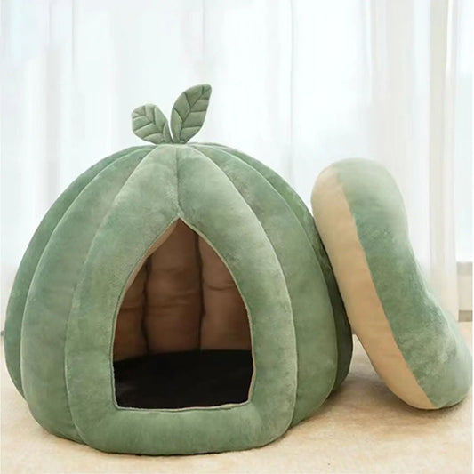 Green pet bed shaped like a pumpkin with leaves on a light background