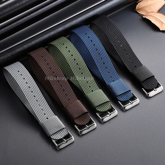 Set of six woven watch straps in various colors on a dark surface.