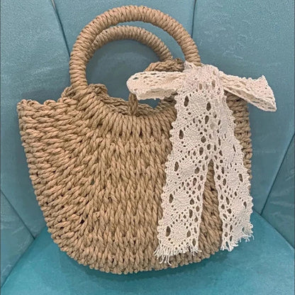 Woven handbag with a lace scarf on a teal cushion