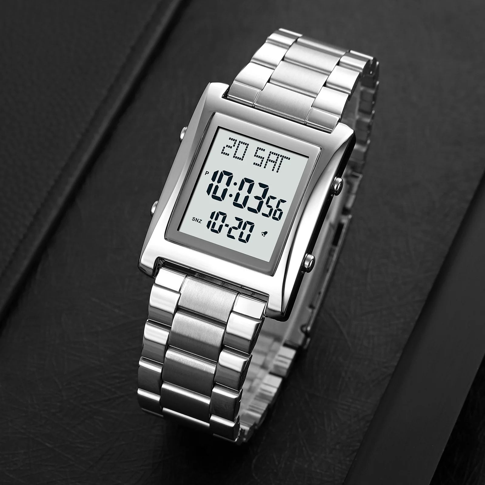 Silver digital watch with a rectangular screen on a dark background