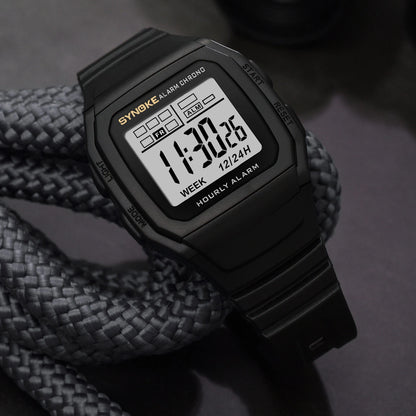 Digital watch with a black strap on a dark background