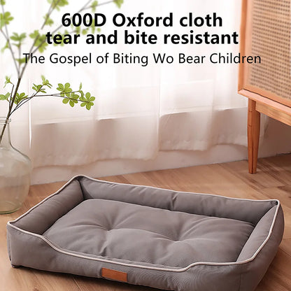Gray pet bed with text about 600D Oxford cloth durability on a wooden floor.