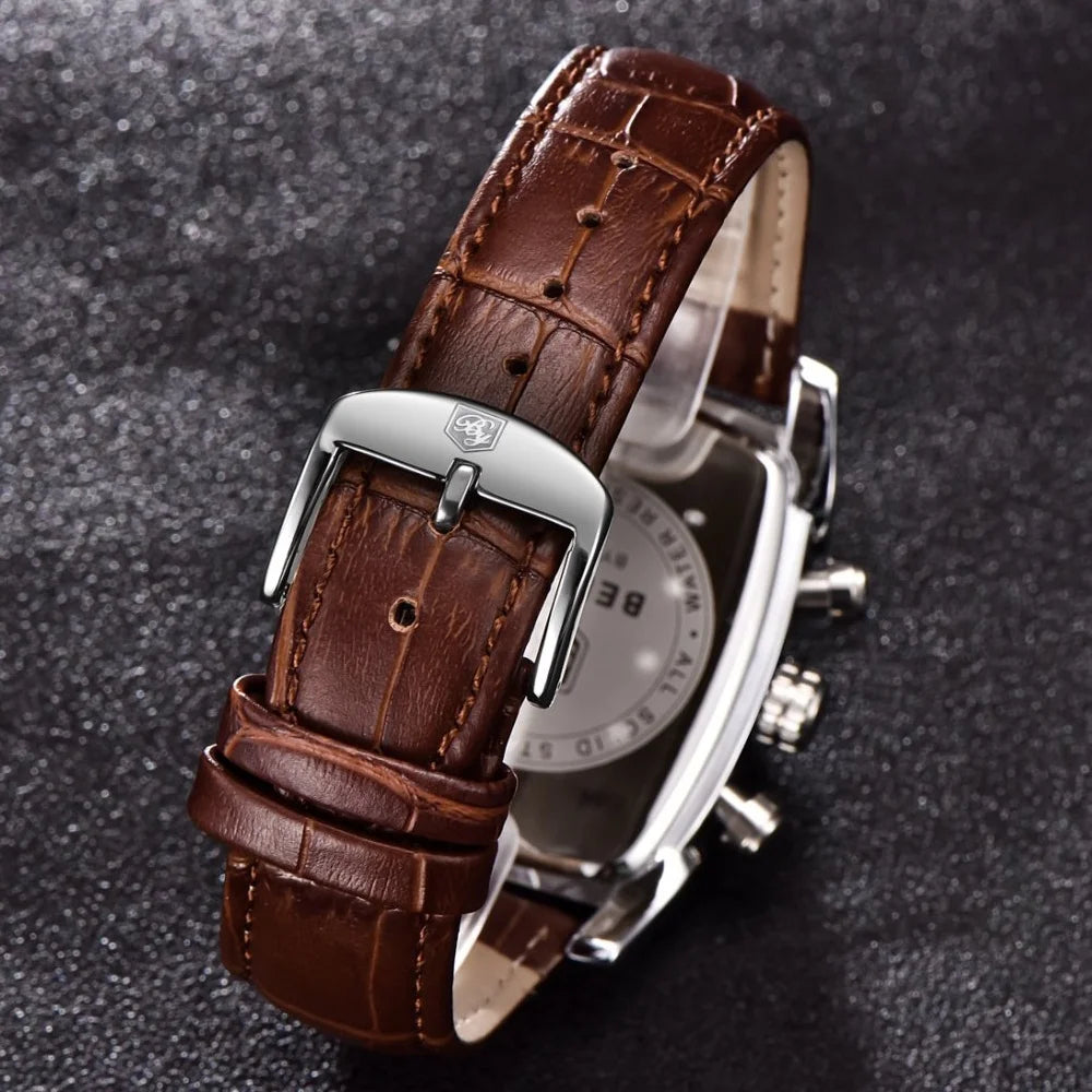 Watch with brown leather strap and silver case on a dark textured background