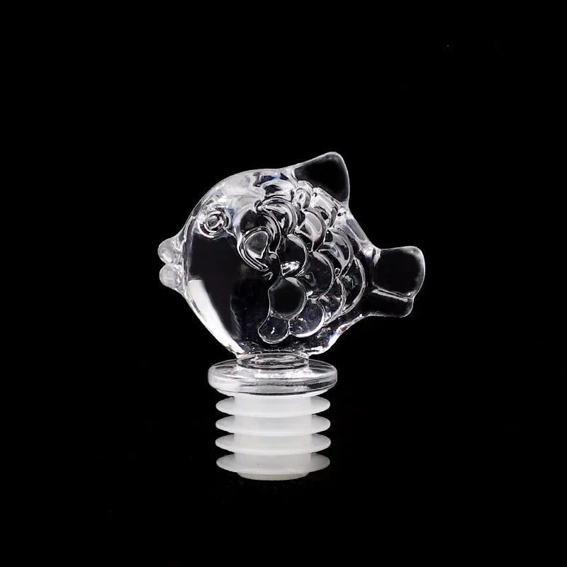 Clear glass fish-shaped object on a black background with Chinese characters '小鱼' above.