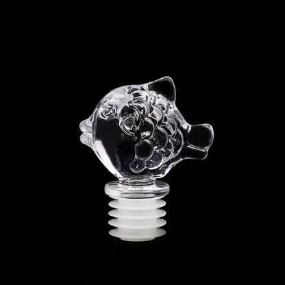 Clear glass fish-shaped object on a black background with Chinese characters '小鱼' above.
