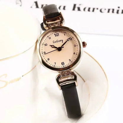 Watch with black strap and rose gold case on a white background