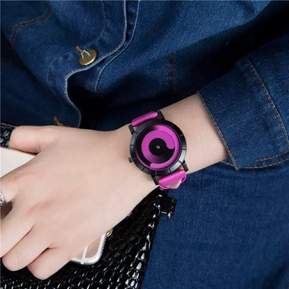 Person wearing a pink and black watch on a denim sleeve