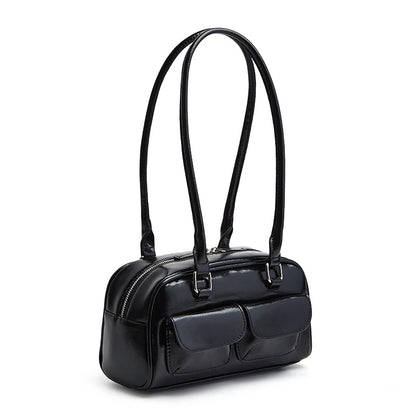 Black handbag with a strap on a white background