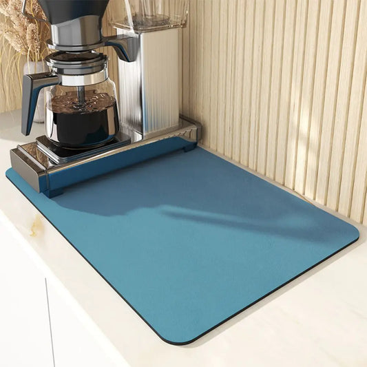 Blue mat in front of a coffee maker on a light-colored surface