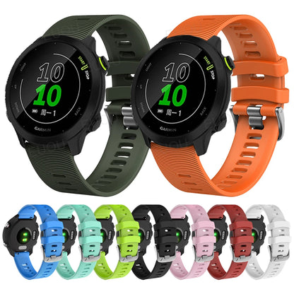 Garmin smartwatches with various colored bands on a white background