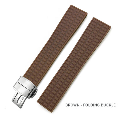 Brown textured watch strap with silver folding buckle on a white background