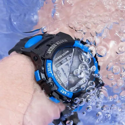 Digital watch with black and blue design being submerged in water