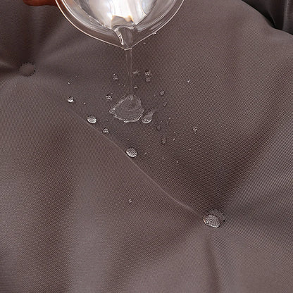 Water droplets being poured onto a gray fabric surface
