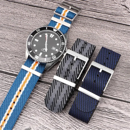 Watch with multiple strap options on a wooden surface