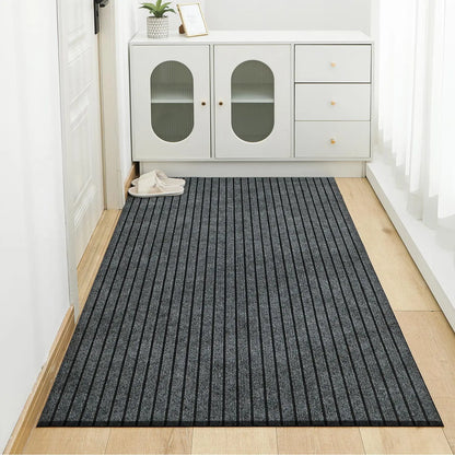 Gray striped rug on a wooden floor in a room with white cabinets.