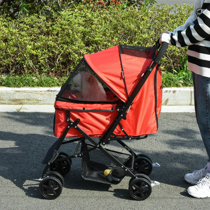 Red pet stroller being pushed on a road with greenery in the background