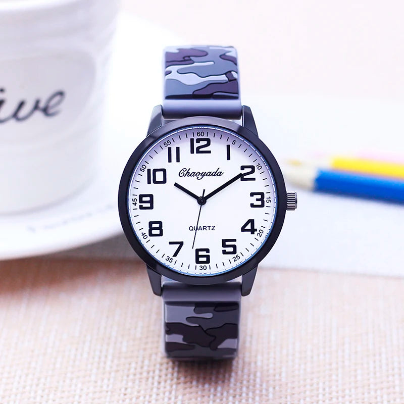 Wristwatch with camouflage band on a light background