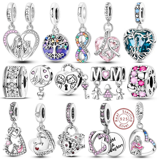 Collection of various silver charms with different designs on a white background