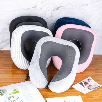 Set of neck pillows in various colors on a wooden surface with a marble background