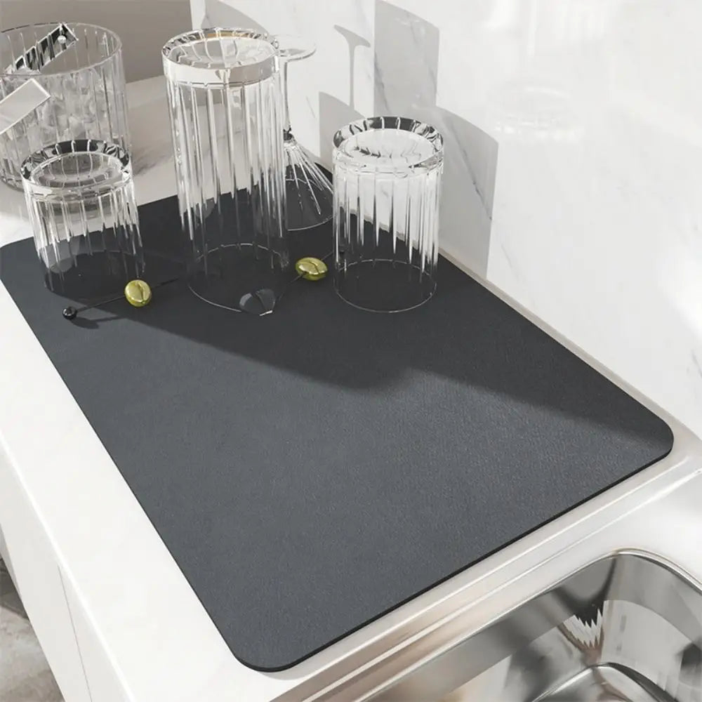 Gray placemat on a kitchen counter with glasses and coins