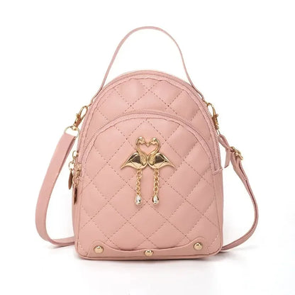 Pink quilted backpack with gold accents on a white background