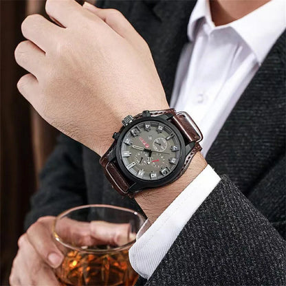 Man wearing a wristwatch with a glass of whiskey in his other hand.