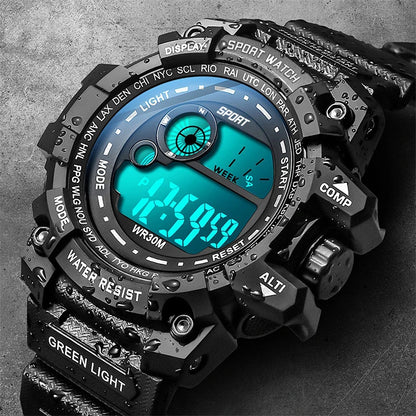 Black digital sports watch with green display on a dark background
