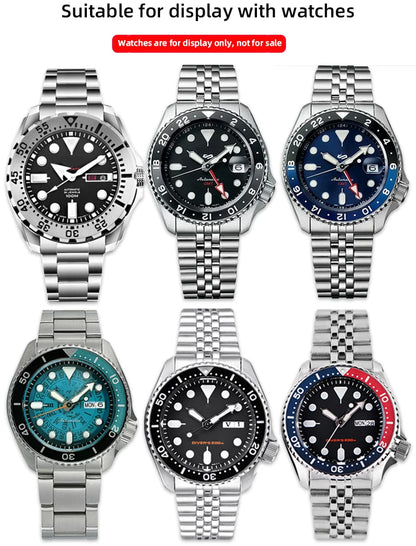 Six silver watches with various colored faces on a white background