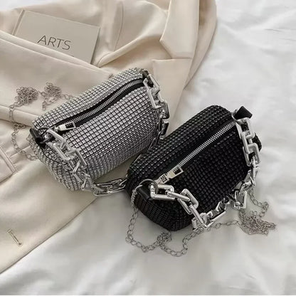 Two rhinestone-embellished bags on a textured surface with 'ARTS' visible.