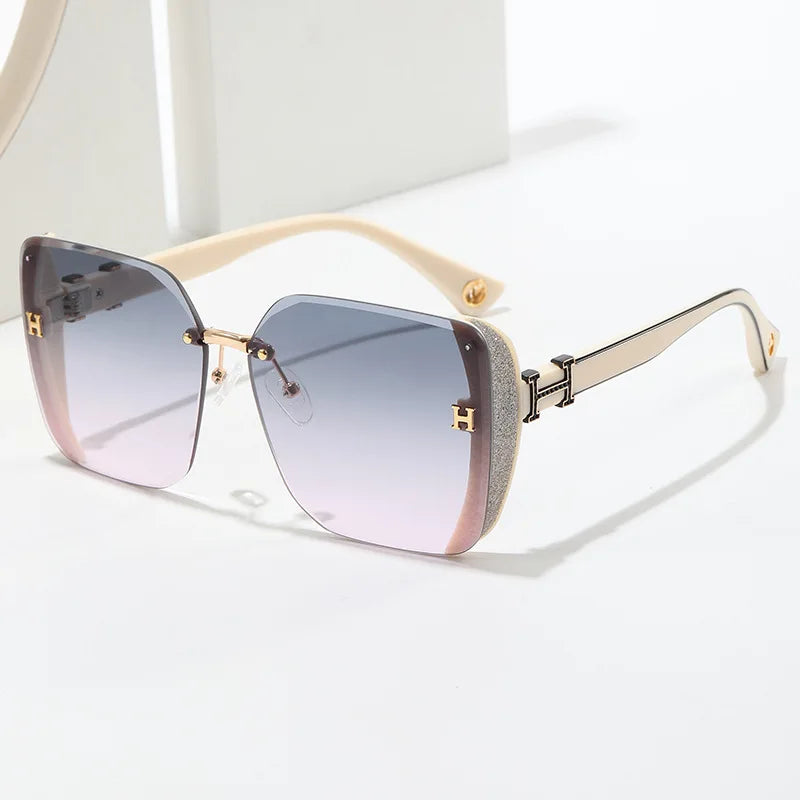 Sunglasses with gradient lenses and gold frame on a white background