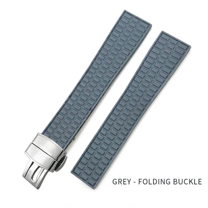 Gray watch strap with a silver folding buckle on a white background