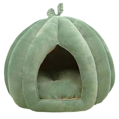 Green pet bed shaped like a pumpkin on a white background
