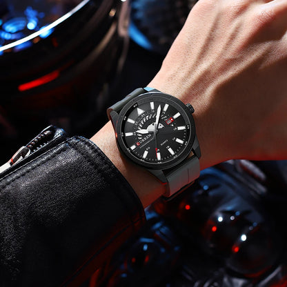 Black wristwatch on a person's wrist with a car interior background