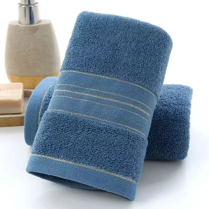 Two blue towels with a decorative stripe on a white background