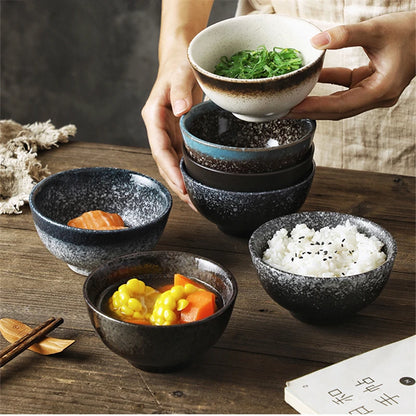 Set of ceramic bowls with food on a wooden table