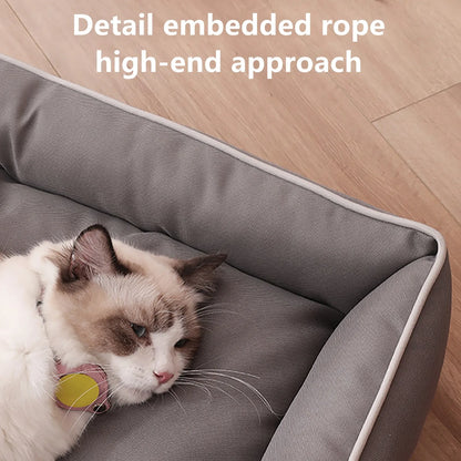 Cat lying in a gray pet bed on a wooden floor