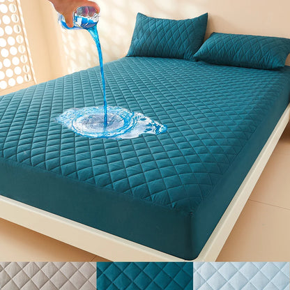 Teal mattress protector with water being poured onto it on a bed.
