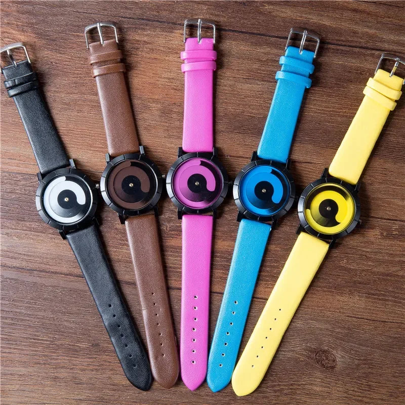 Five watches with different colored straps on a wooden surface