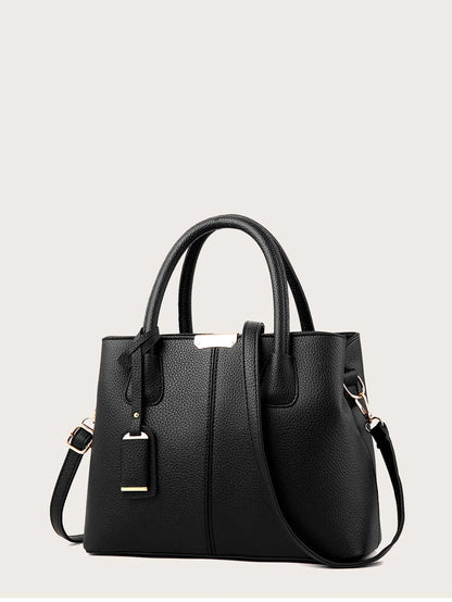 Black handbag on a light gray background