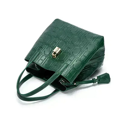 Green textured handbag with a gold clasp on a white background