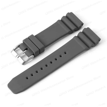 Gray watch strap with silver buckle on a white background