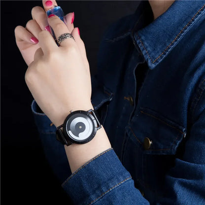 Person wearing a watch with a dark strap and white face, set against a dark background.
