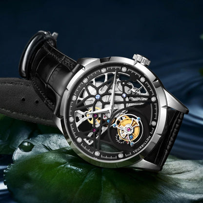 Luxury watch with black leather strap on a dark background