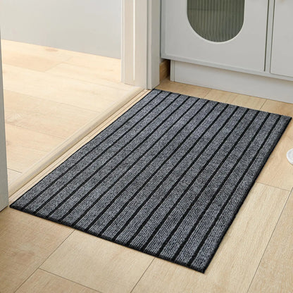 Black striped doormat on a wooden floor in a home setting