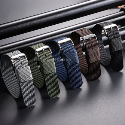 Set of six watch straps in different colors on a metallic surface