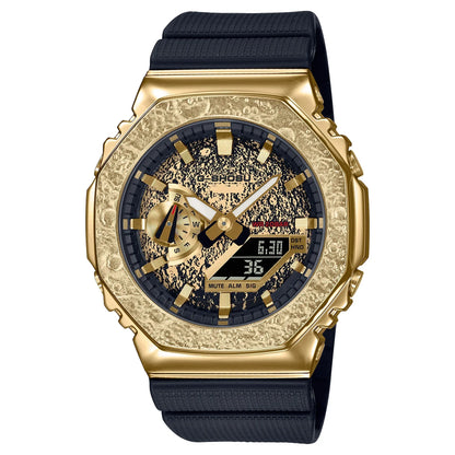 Gold and black watch with detailed face on a white background