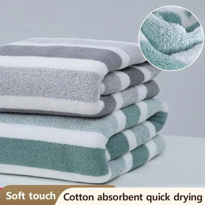 Stack of striped towels with close-up of texture on a gray background