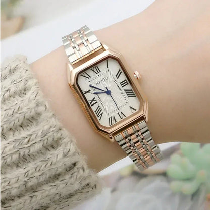 Rose gold watch on a wrist with a blurred background